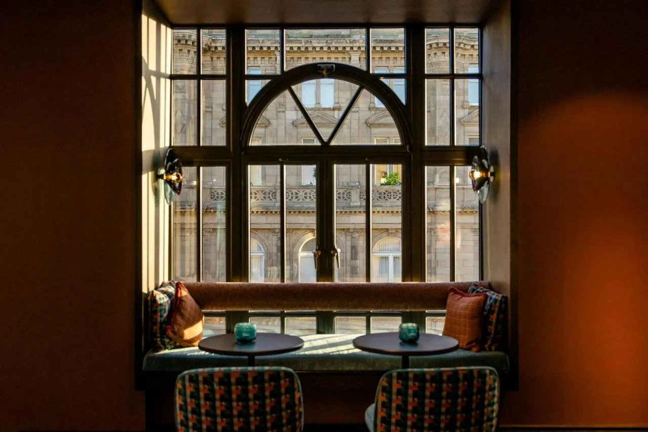 a window in a room with two tables in front at Motel One Edinburgh-Princes in Edinburgh
